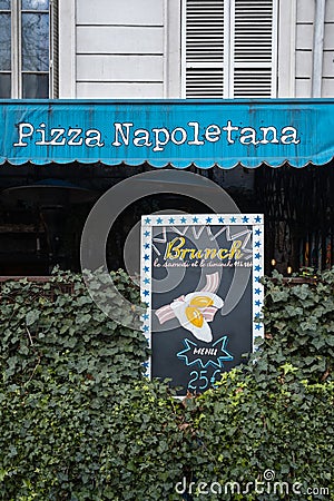 Blue awning with text: Pizza Napoletana and Brunch sign. The Brooklyn Pizzeria in Paris, France Editorial Stock Photo