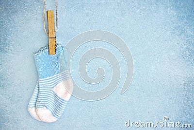 Blue baby socks on a textured background Stock Photo