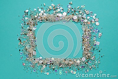 Blue background.Frame made of of sequins and beads Stock Photo