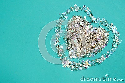 Blue background with heart of sequins and beads Stock Photo