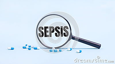 On a blue background, white and blue capsules with pills and a black magnifying glass with the text SEPSIS. Medical concept Stock Photo