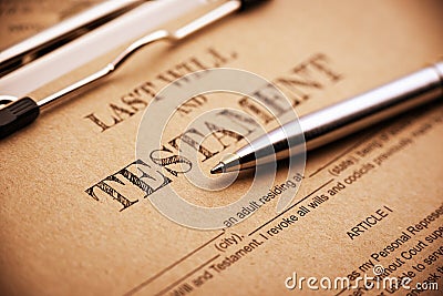 Blue ballpoint pen and a last will and testament on a clip board. Stock Photo