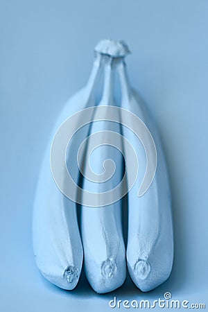 Blue bananas on a blue background. Minimal style Stock Photo