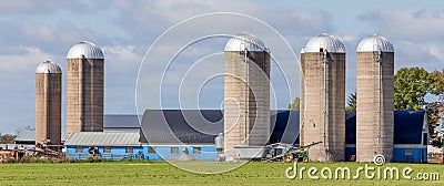 Blue Barn and Buildings with Green Pasture Foreground Panorama Stock Photo