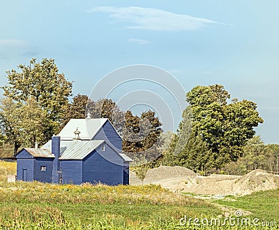 blue barn and storage with sand pile Stock Photo