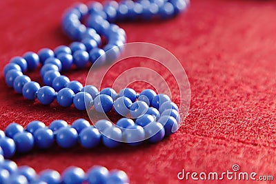 Blue beads on a red background Stock Photo