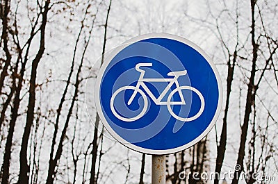 A blue bicycle sign sign signifying a bike path. Stock Photo