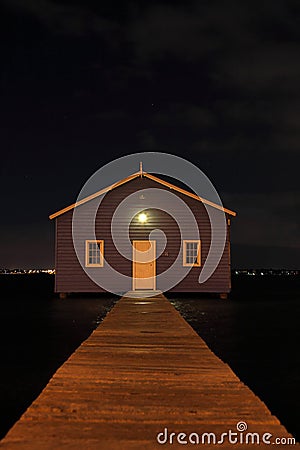 Blue boat house on river at night Stock Photo