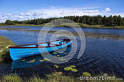 Blue boat in a lake Stock Photo