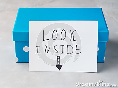 Blue box with paper card Look Inside Stock Photo