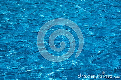 Blue and bright ripple water surface in swimming pool with sun reflection Stock Photo