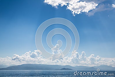 Blue bright sky background on the ocean with clouds and emotional mood for dreams, mourning, death concepts. Stock Photo
