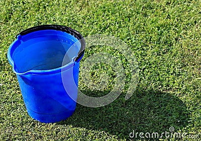A blue bucket filled with water Stock Photo