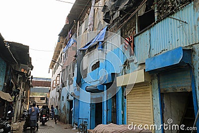 Blue buildings in a street in Dharavi Editorial Stock Photo