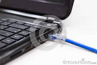 blue cable network connection to a Lan port Stock Photo