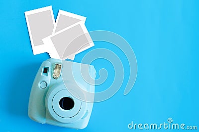 Blue camera with blank picture frames on colourful background. Fashion Film Camera. Nostalgia photography. Top view. Minimal and m Stock Photo