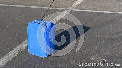 Blue canister on the pavement in sunny day Stock Photo
