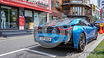 Blue car BMW i8 rear view, stands by the glass wind of a shop in downtown Seoul Editorial Stock Photo