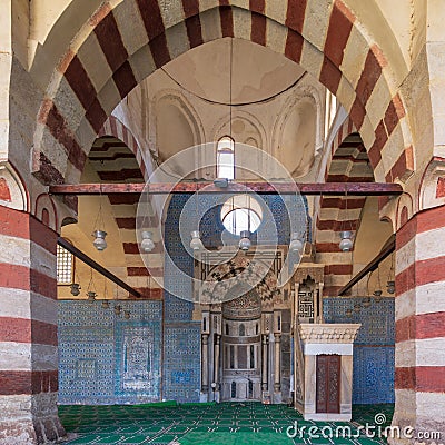 Blue Iznik ceramic tiles wall with engraved Mihrab niche and decorated marble Minbar Platform, Blue Mosque, Cairo, Egypt Stock Photo