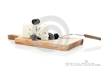 Blue cheese and black olives on cheeseboard Stock Photo