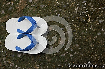 Blue children`s slippers on cement floor Stock Photo
