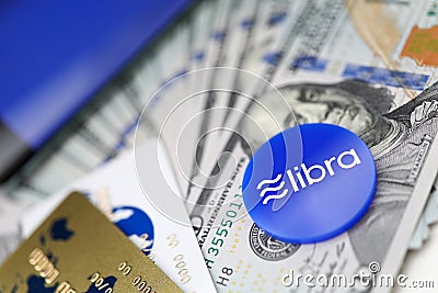 Blue chip with libra sign lying on big pile of US dollars Editorial Stock Photo