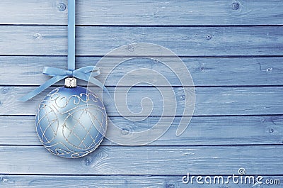 Blue Christmas baubles with curly ribbon on a blue wooden board with copy space. Simple Christmas card Stock Photo