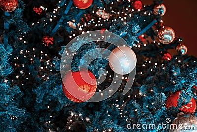 Blue Christmas tree with lots of red balls and white baubles Stock Photo