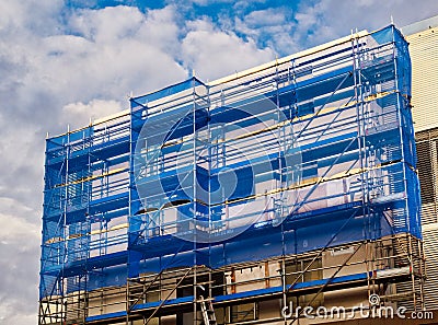 Blue Cladding on Building Scaffolding Stock Photo