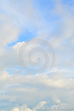 A blue cloudy sky with many small clouds blocking the su Stock Photo
