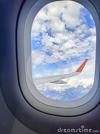 Sky with the airplane wing outside the window. Stock Photo