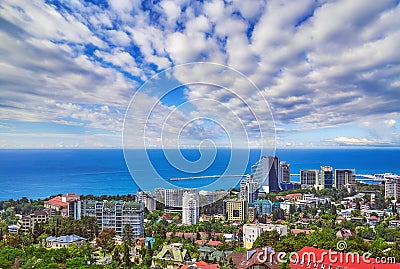 Blue coast of Black Sea in Sochi city with residential houses and recreation areas under summer cloudy sky Editorial Stock Photo