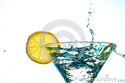 Blue cocktail water drink splash in the glass with lemon Isolated on white Stock Photo