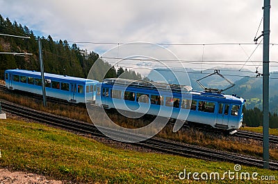 Blue cogwheel train on Rigi Mountain, Swiss Alps Editorial Stock Photo
