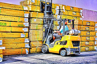 Blue Collars finistest fork lift driver grabs another stack of lumber Stock Photo