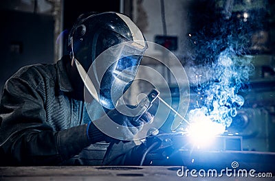 Blue color Industry worker banner. Welder work with metal parts car in factory, sparks and electricity Stock Photo