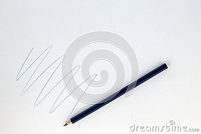 Blue color pencil drawing zigzag on white paper . Stock Photo