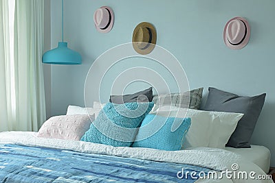 Blue color scheme teenager bedroom with hats on wall Stock Photo