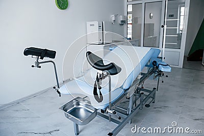 Blue colored obstetric bed indoors in the clinic cabinet at daytime Stock Photo