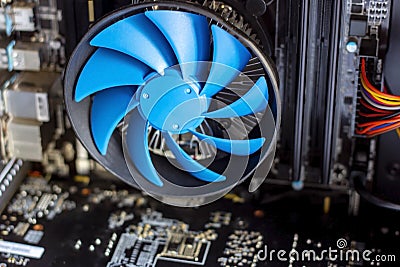 Blue cooler fan with motherboard inside a computer Stock Photo