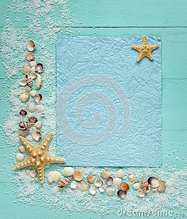 Blue crumpled sheet of paper on turquoise style. Place for text. Decor of seashells. Top view Stock Photo