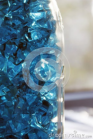 Blue crystals of glass with highlights of light on them, blur, close-up, abstraction Stock Photo