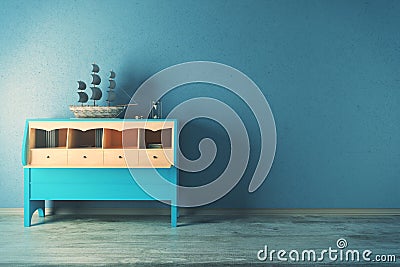 Blue cupboard with ship in room Stock Photo