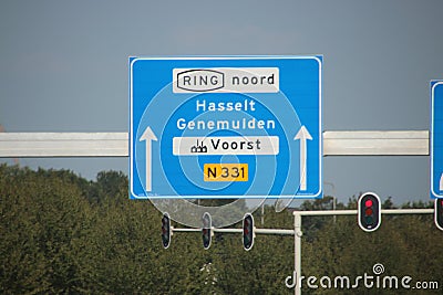 Blue direction sign heading Hasselt and Genemuiden at N331 in Zwolle Editorial Stock Photo