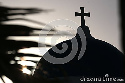 Blue dome of church as silhouette again the sunrise in Santorini, Greece Stock Photo