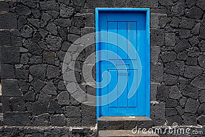 Blue door lava stone masonry wall at La Palma Stock Photo