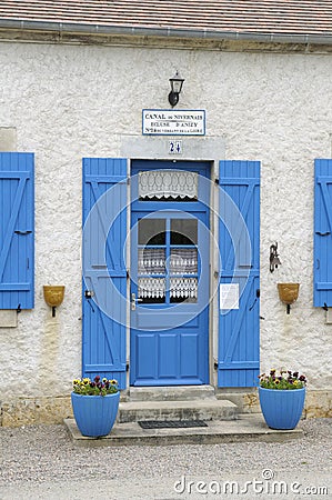 Blue door and shutters at the lock keepers house, Ecluse 24 Anizy, Champ du Pont, Limanton, Nievre, Burgundy Editorial Stock Photo