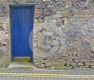 Blue Door in a Stone Wall Stock Photo