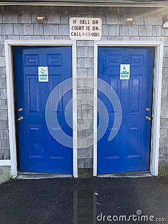 Blue doors, Buoys and Gulls Restroom signs Stock Photo