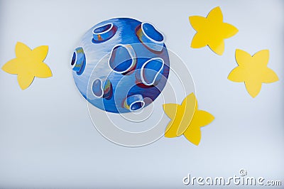 Blue drawn planet and yellow stars around lay on white background Stock Photo